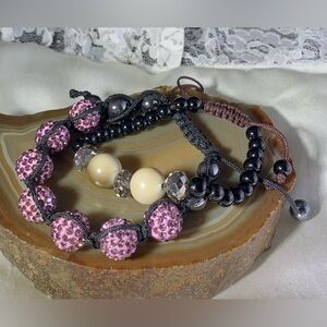 2 ADJUSTABLE BRACELETS MADE TO FIT MOST SIZES